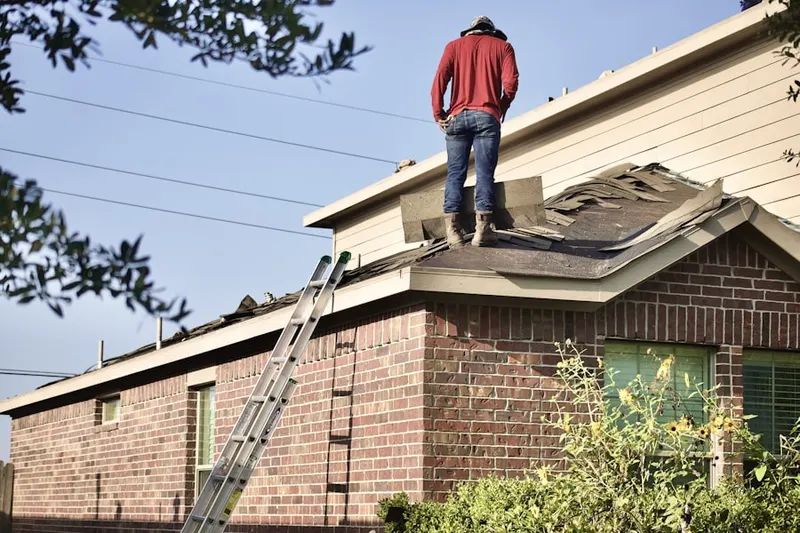 Professional roofer working on a residential roof in Fruitdale